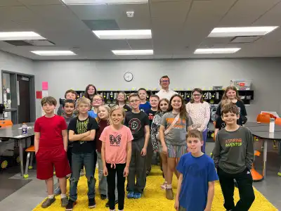 Image of a volunteer with group of students